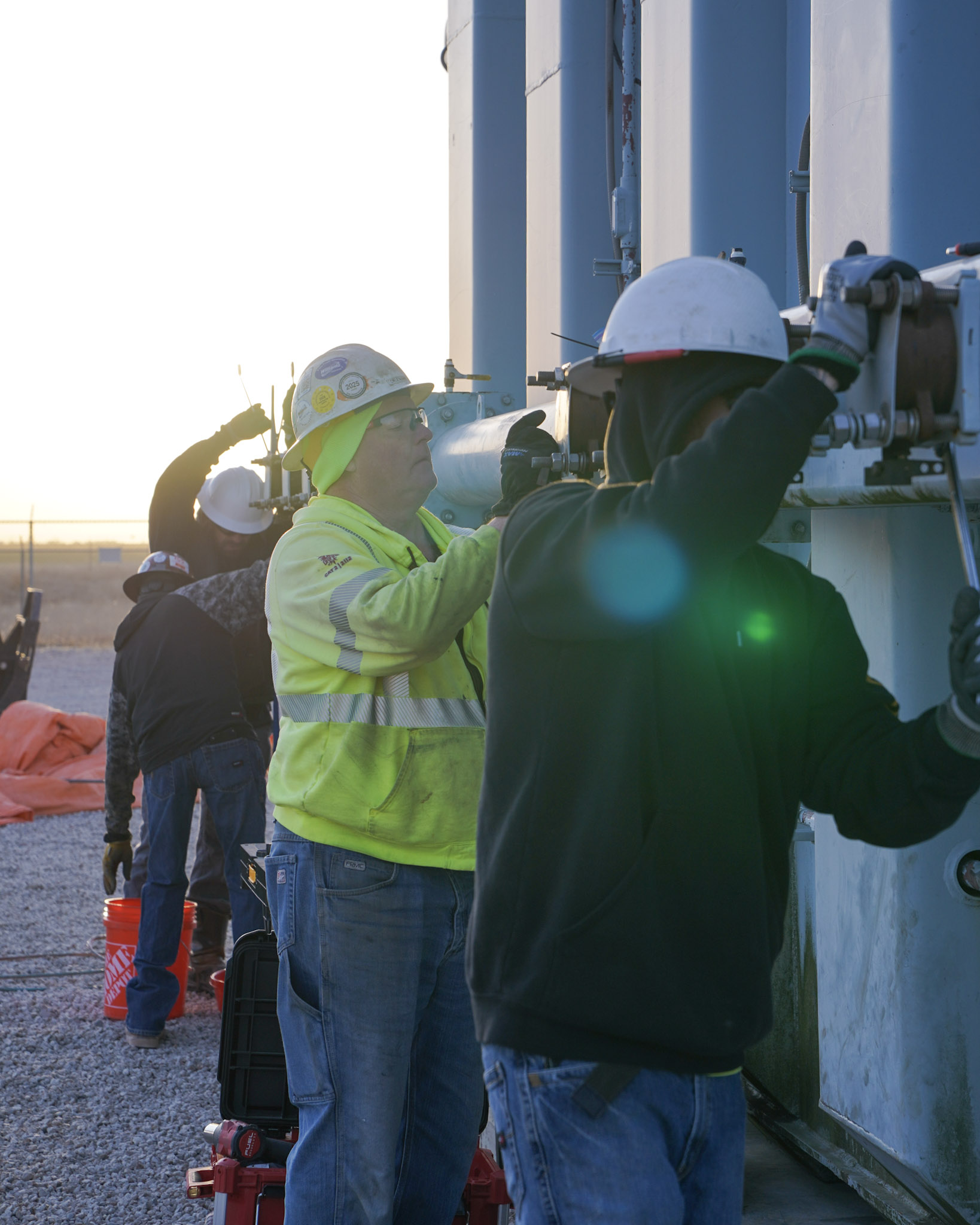 JCL crew working on a substation transformer at sunrise