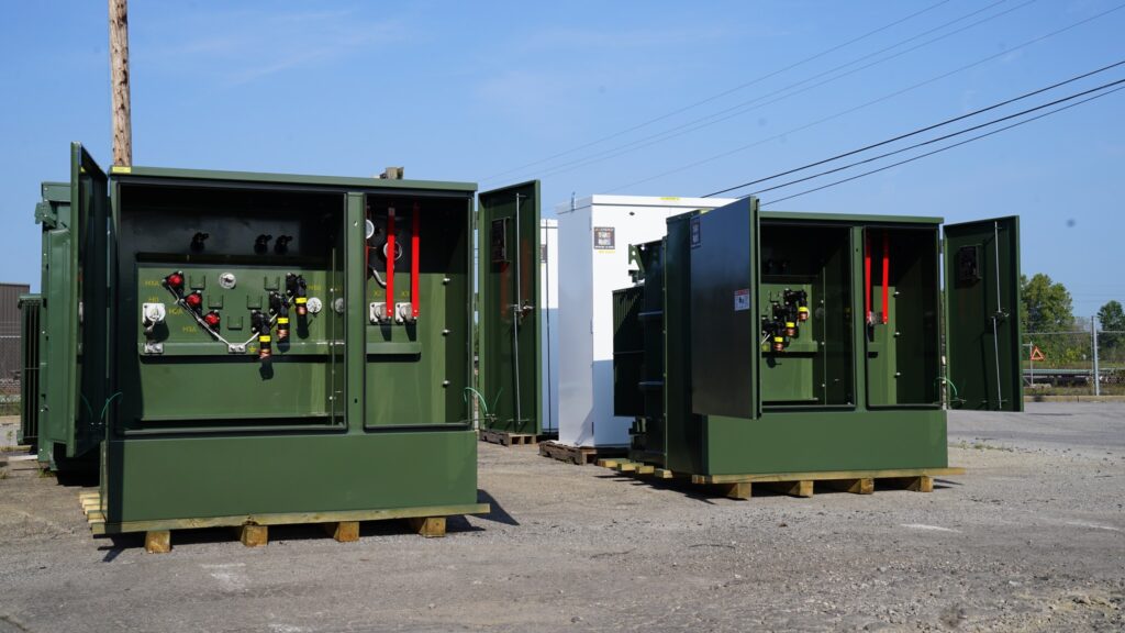 Industrial transformers of various types arranged outdoors, highlighting the different types of transformers used for efficient power distribution in industrial settings