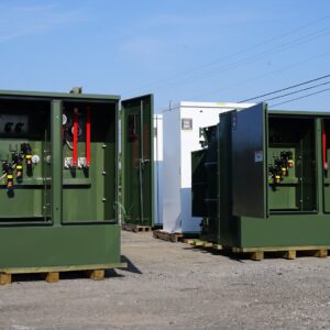 Industrial transformers of various types arranged outdoors, highlighting the different types of transformers used for efficient power distribution in industrial settings