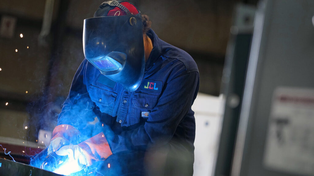 technician conducting tests on a distribution transformer manufacturing process