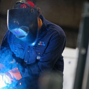 technician conducting tests on a distribution transformer manufacturing process